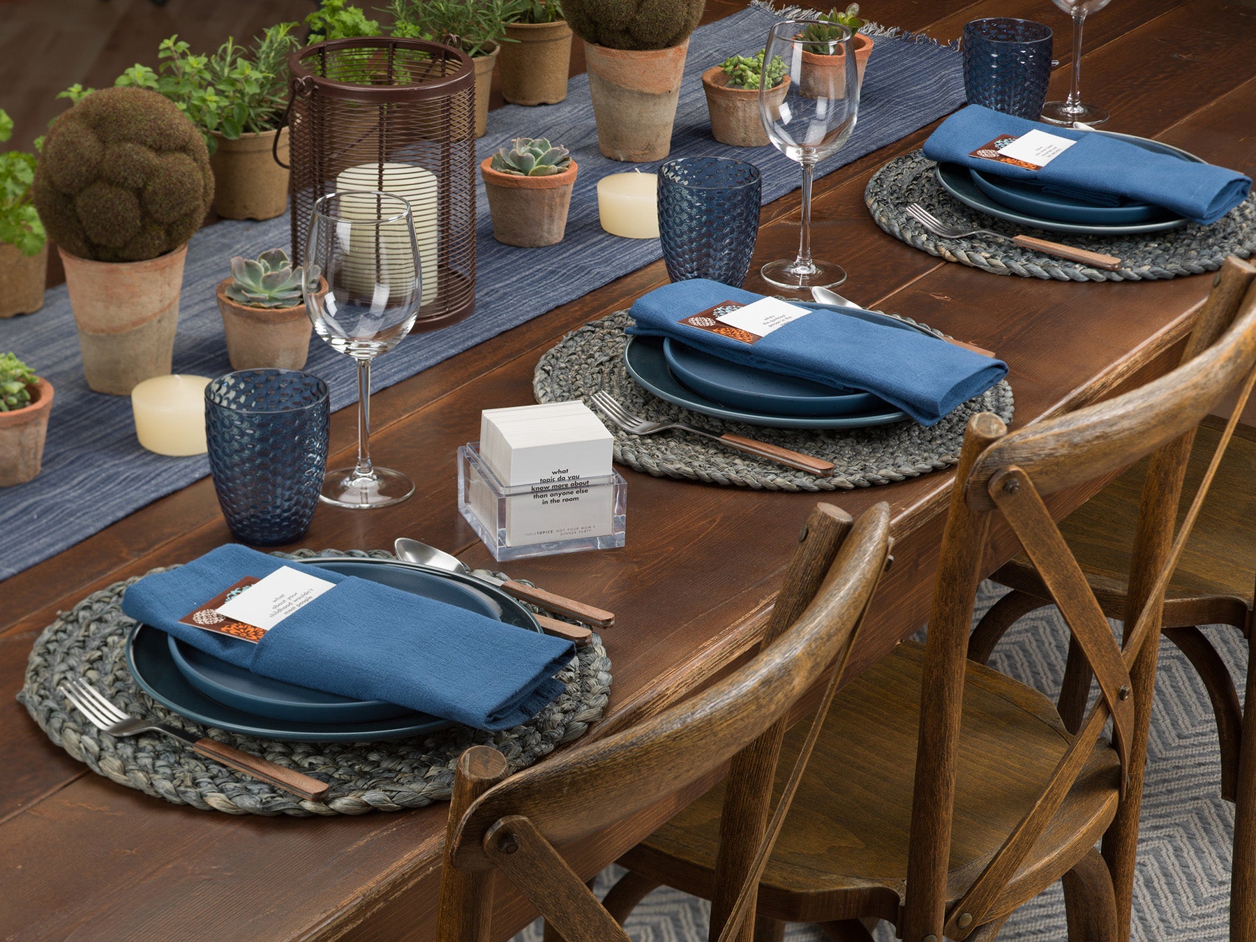 Dinner party tablescape with TableTopics cards on the napkins