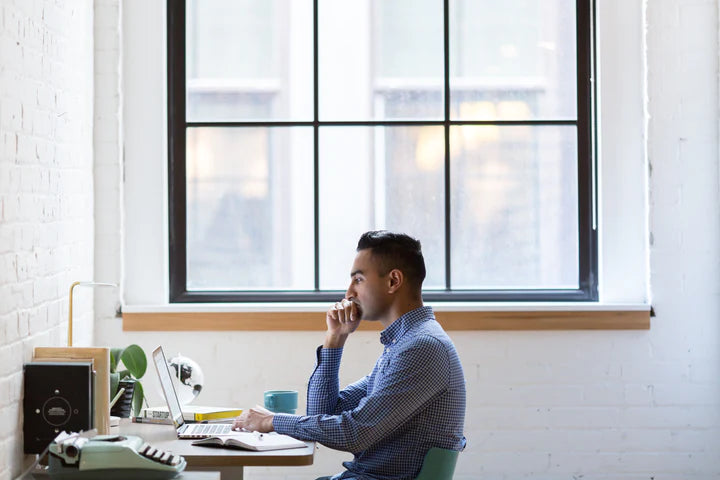 Man with tired eyes at a computer