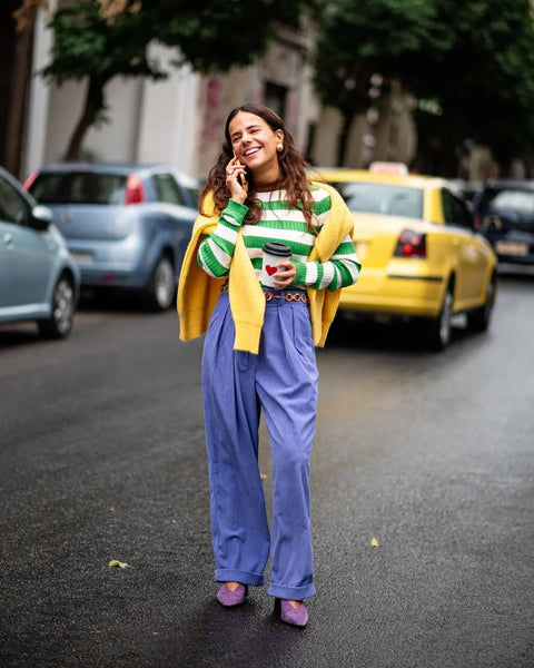 girl wearing colourful clothes and talking to the phone