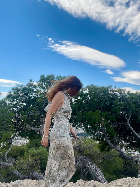 woman wearing a mint jumpsuit with flowers