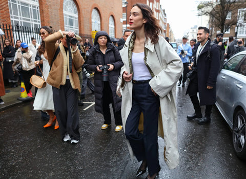 TV presenter Alexa Chung in sand overcoat, blue slacks and white tank top