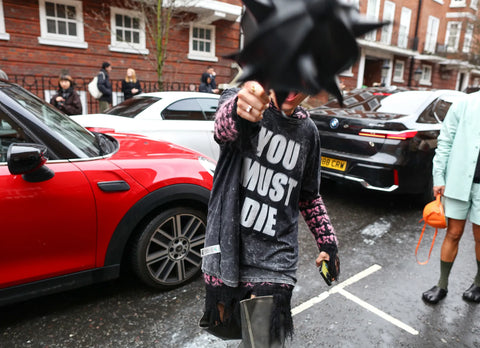 person with a t-shirt with slogan "you must die"