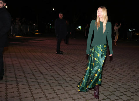 woman with green top and green printed skirt