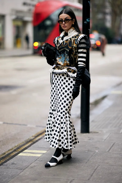 woman with printed blazer and polka dot maxi skirt