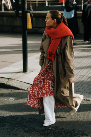 woman with white pants, red scarf and red-white dress worn as a top