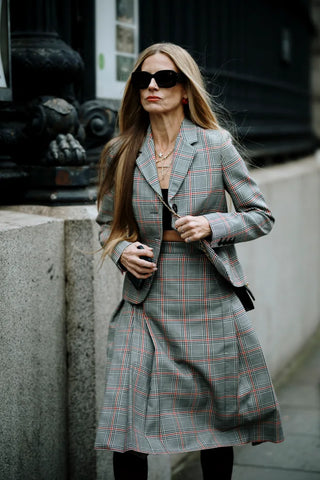 woman with grey checkered blazer and skirt