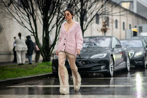 woman with pink cardigan and sheer vanilla wide pants