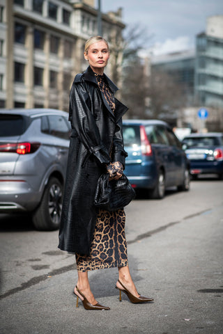 woman with animal printed dress and leather overcoat
