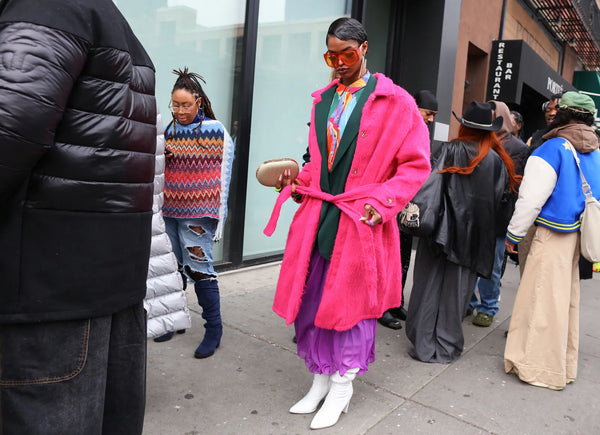 woman with colourful outfit and fuchsia coat