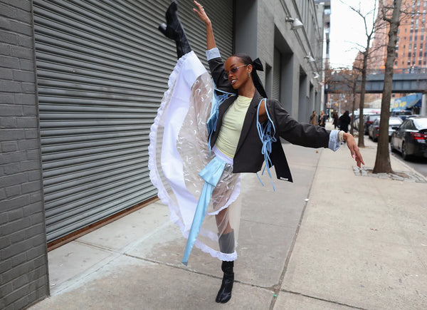 woman with white tulle skirt striking a ballet pose