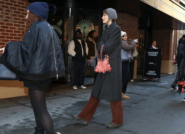 woman with simple outfit and flashy handbag