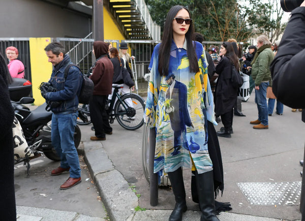woman with a long printed shirtdress in blue shades and black boots