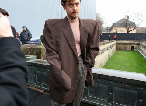 man with an oversized brown jacket with structured shoulders
