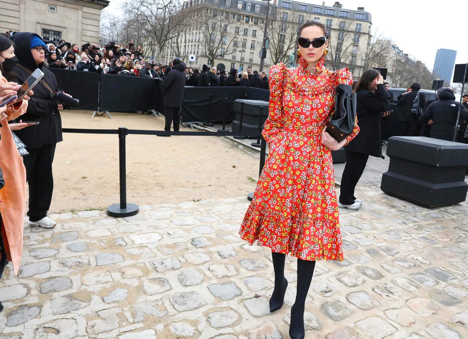 woman in printed red dress and black sunglasses