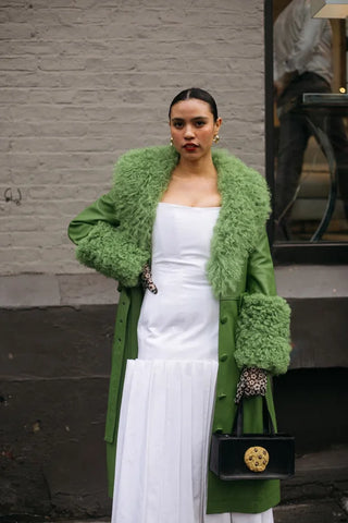 woman with white dress and green coat