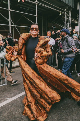 woman with black outfit and huge puffer brown coat