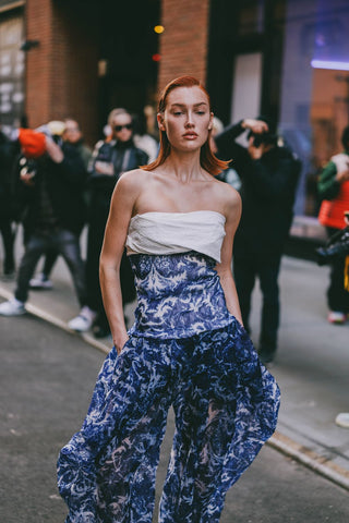 woman with strapless jumpsuit in white and blue print