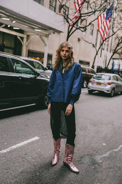 woman with denim blouse, black skirt and metallic pink boots