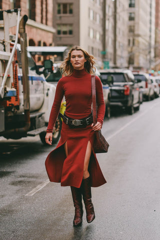 woman with warm red dress with front slits