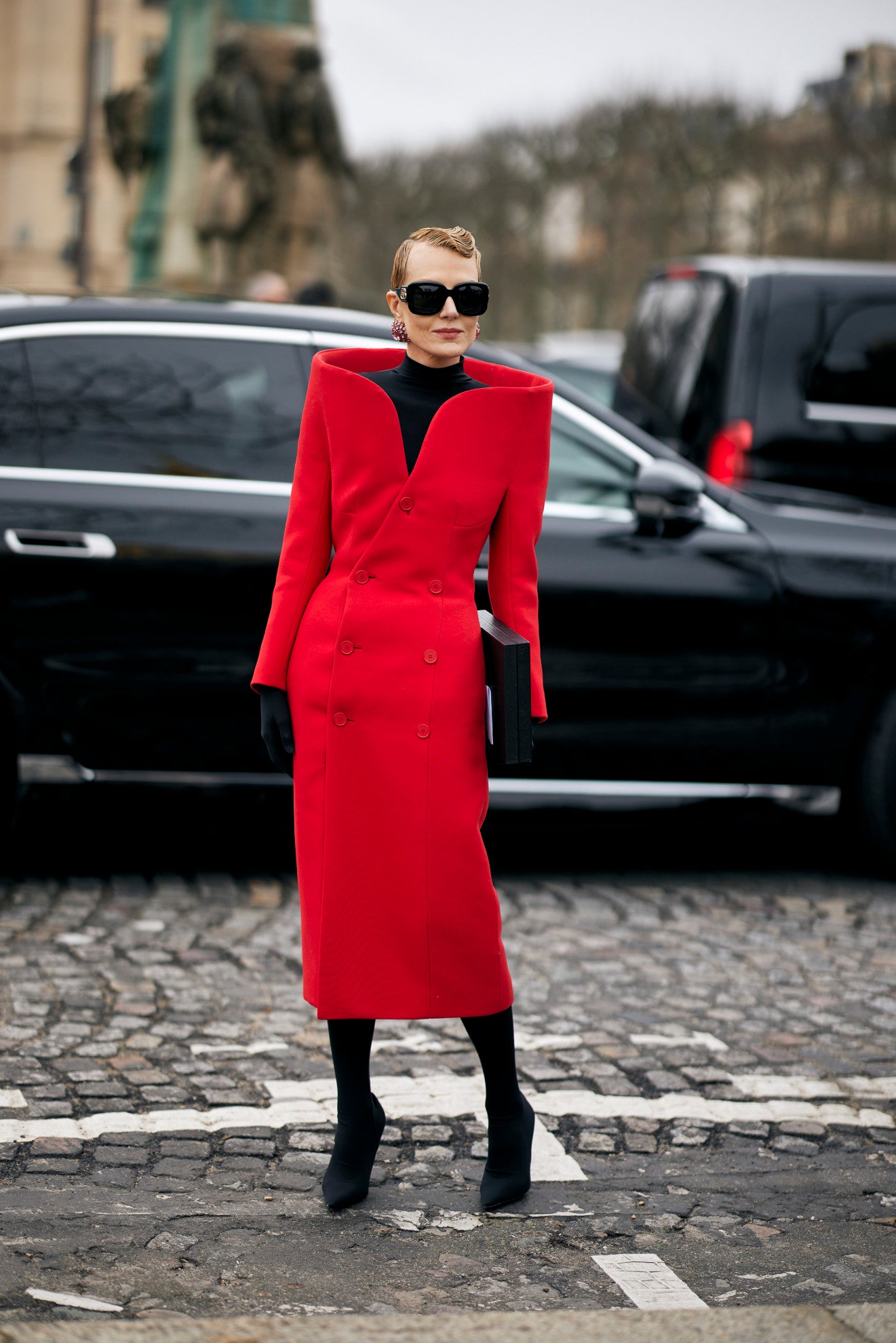 woman in red structured midi dress
