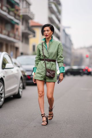 woman in denim green playsuit and a green shirt underneath