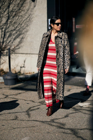 woman with animal printed coat and red-white knitted dress