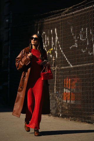 woman with warm red long dress and brown coat