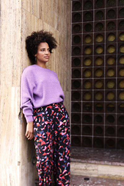 woman with printed pants and lilac top