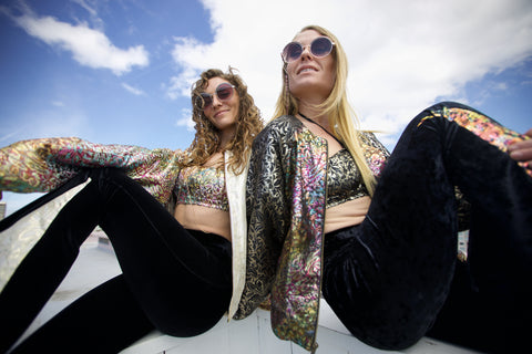 two women posing in metallic outfits