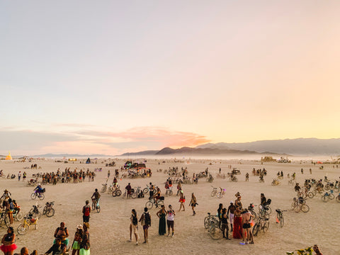 crowd of people dressed in costumes and on bikes at Burning Man 2019