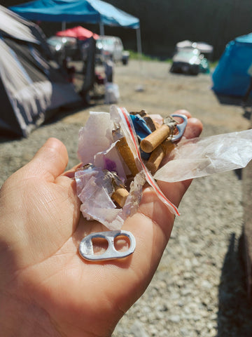 Handful of trash that is missed when camping like bottle caps, fuzz 