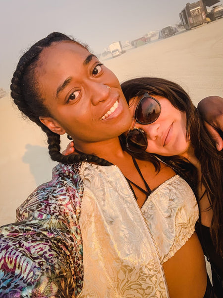 Two women posing wearing poppy california clothing at burning man