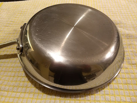 a frying pan that has been cleaned and is now free of grease stains.