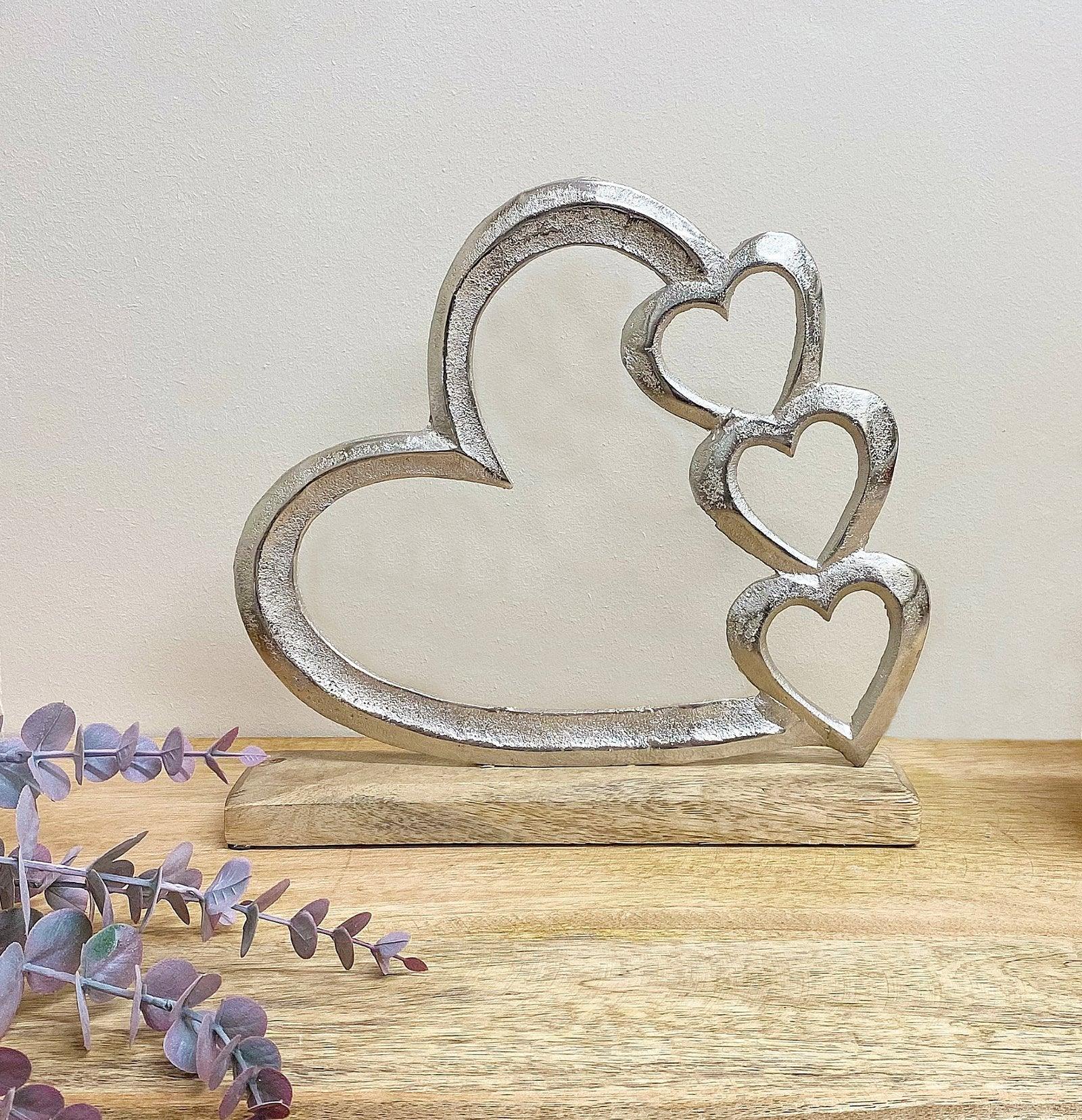 View Metal Silver Four Heart Ornament On A Wooden Base Large information