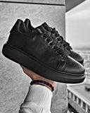 Pair of black sneakers with black rubber sole