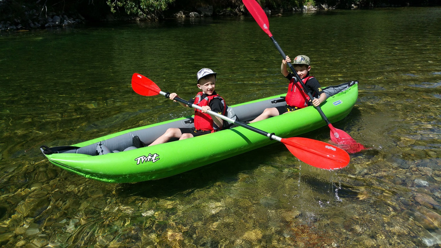 Children wearing buoyancy aids on a kayak