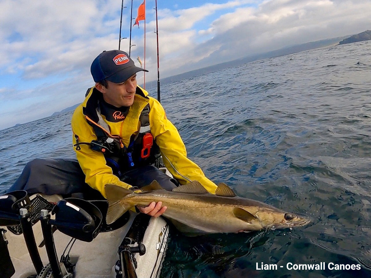 Lia from Cornwall Canoes with a Pollack caught on his Hobie Kayak