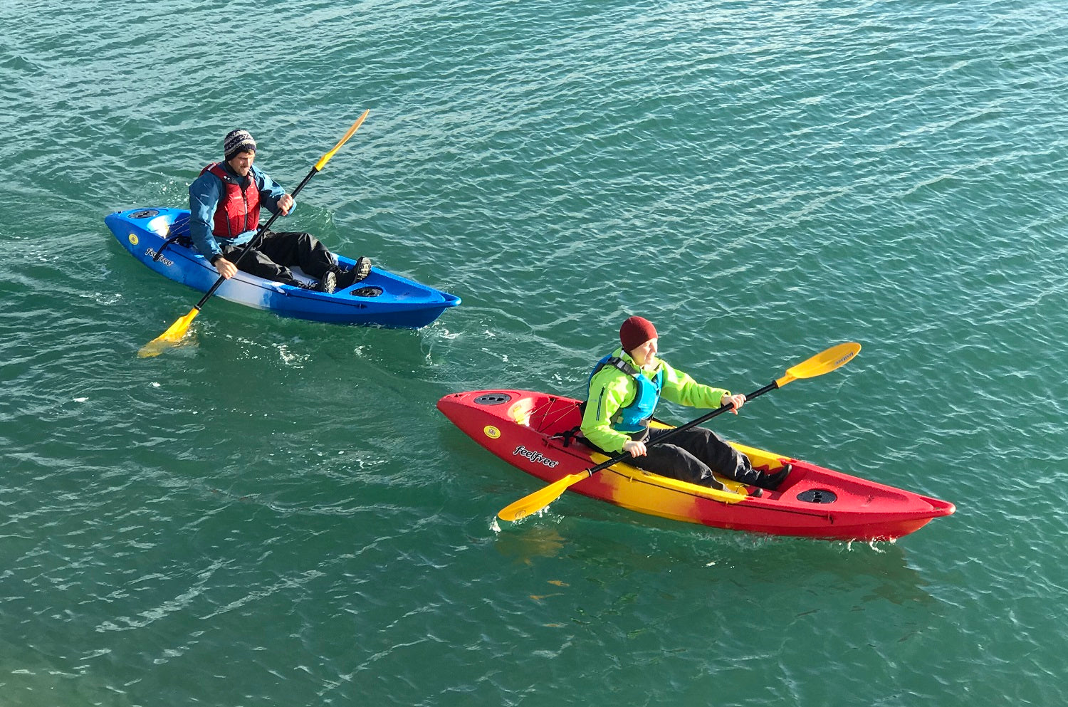 Paddling sit on top kayaks wearing a buoyancy aid for safety