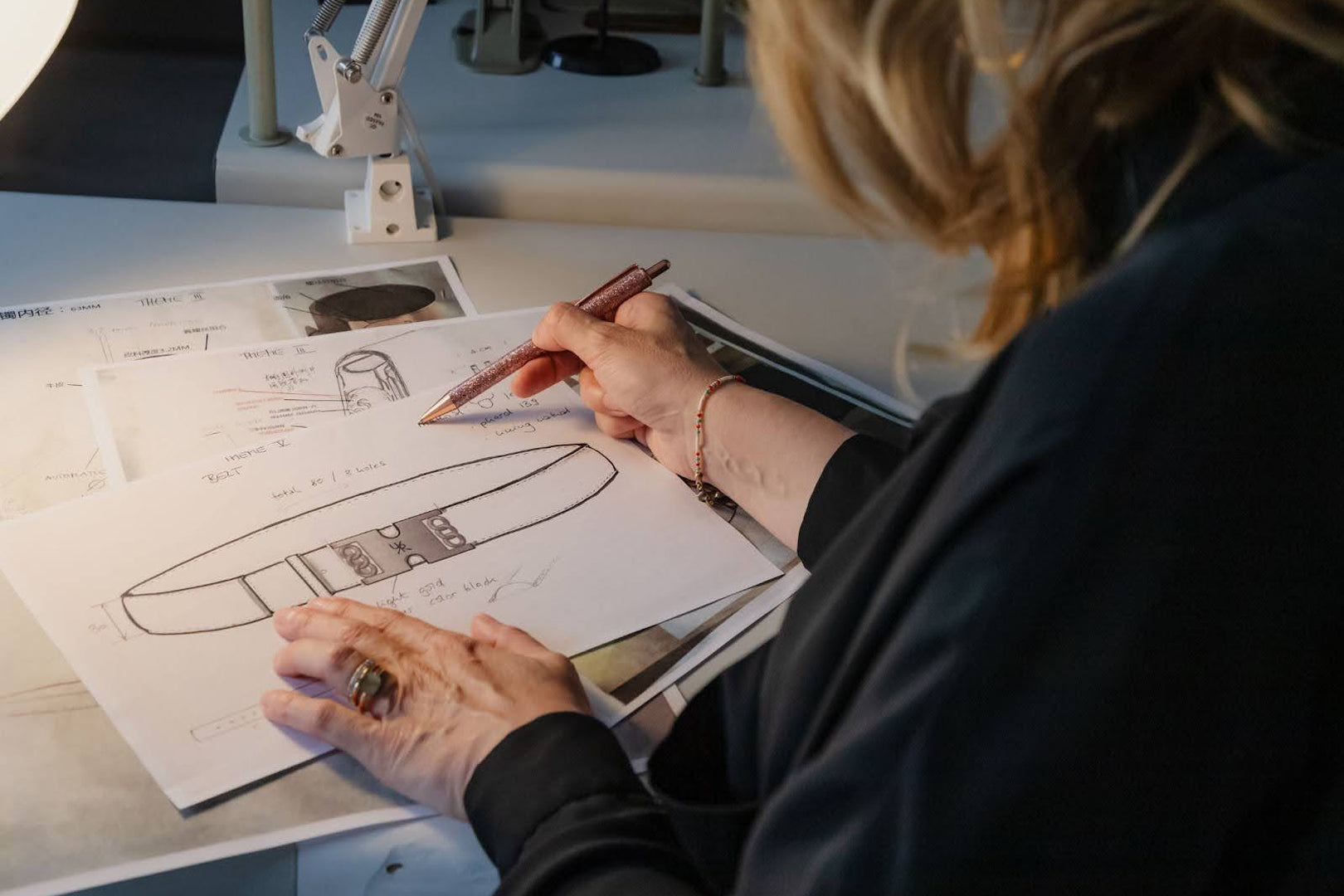 Fashion designer sketching a sustainable clothing design, focusing on natural materials for a green wardrobe.