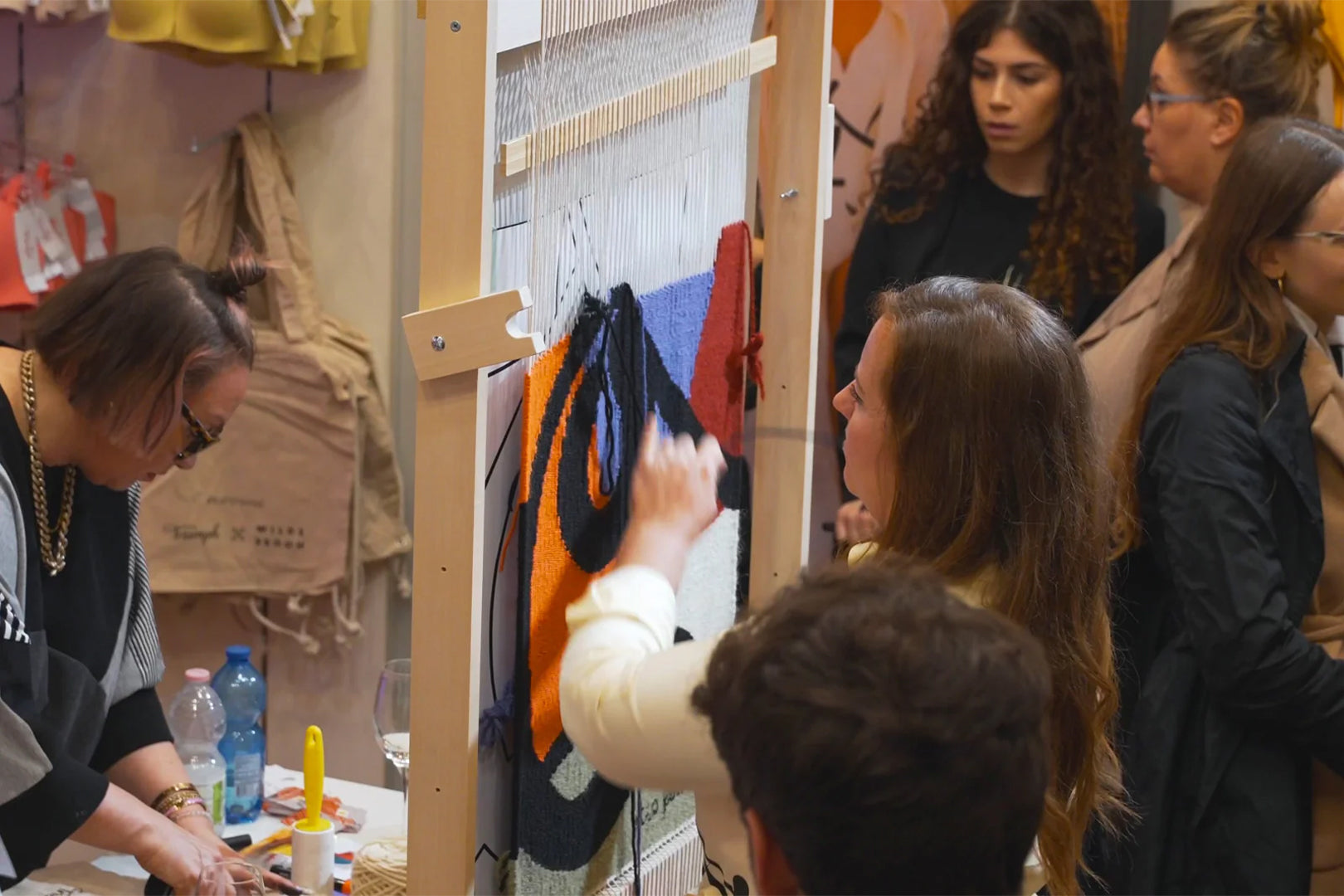 Participants engaging in an embroidery workshop, learning about environmentally friendly fashion textile production.