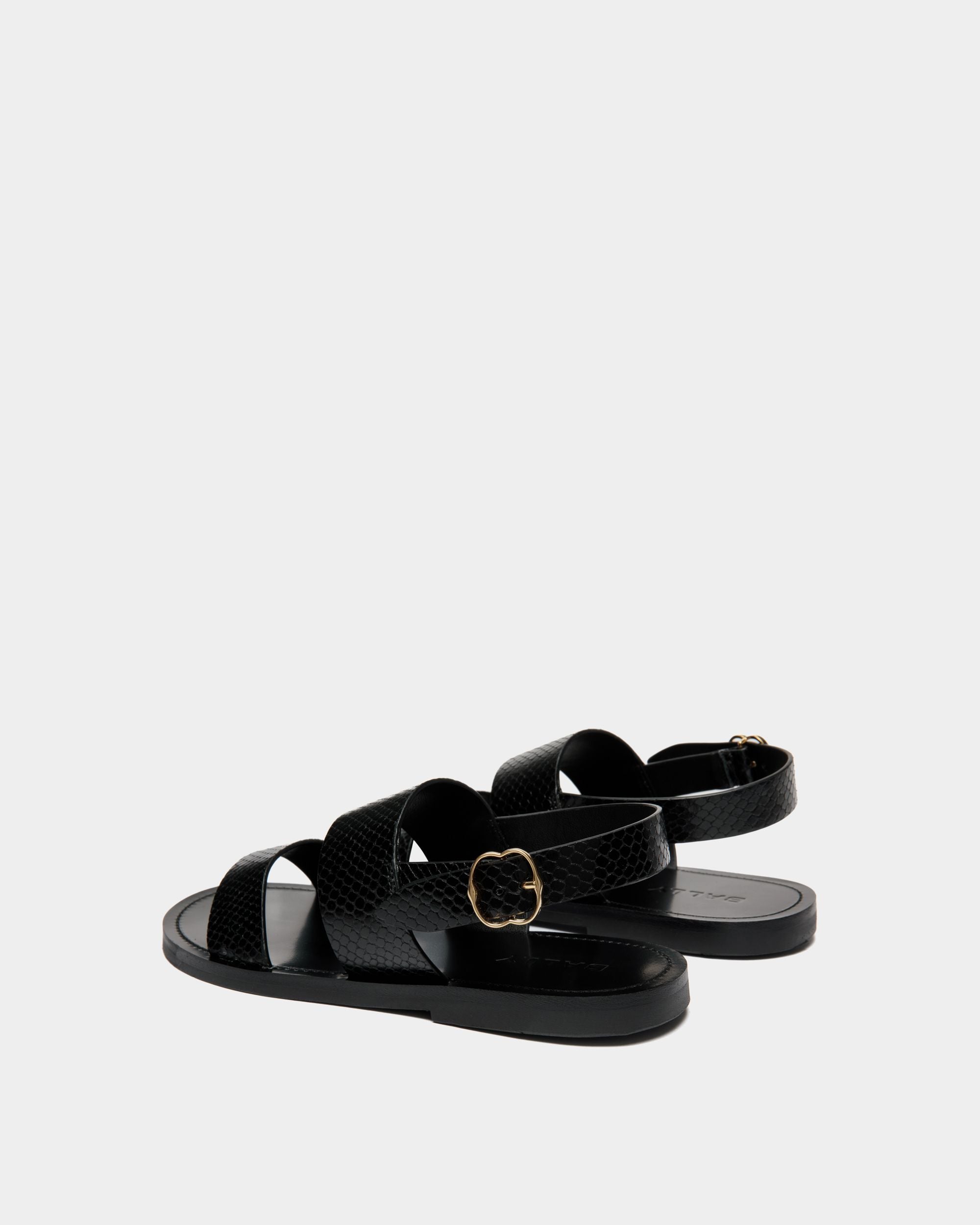 Baudy | Women's Flat Sandal in Black Python Printed Leather | Bally | Still Life 3/4 Back