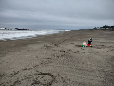 Kids playing on quiet Moonstone beach on an overcast day in Cambria