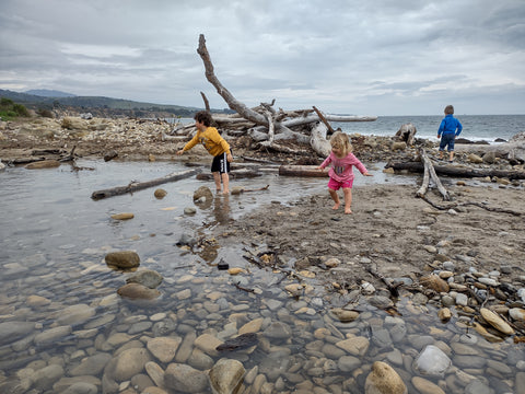 Kids playing in a creek near the ocean at El Capitan State Beach in Santa Barbara county