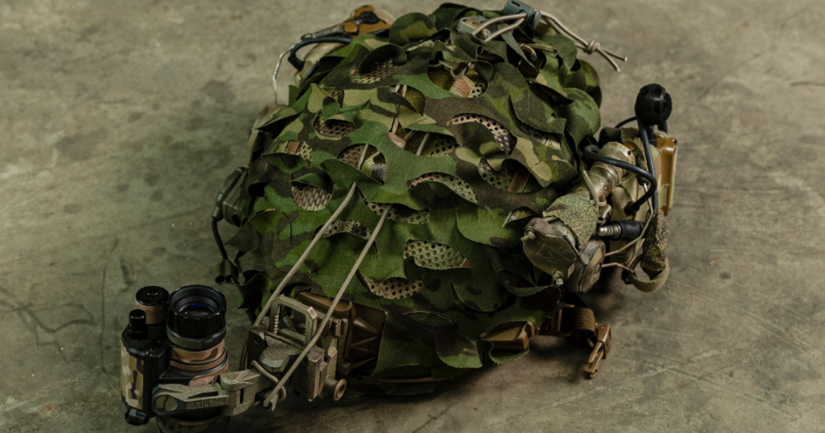 OHC HelmetScrim in green laying on concrete floor.