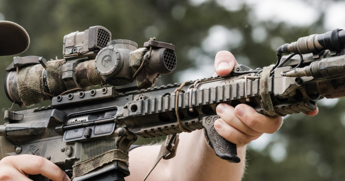 a man aiming his rifle equipped with One Hundred Concept's ScopeCap