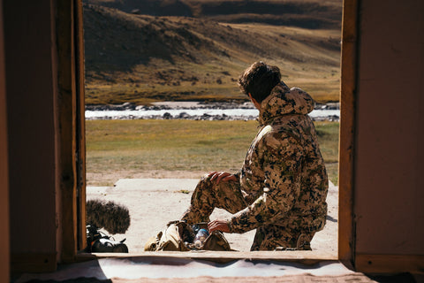 Ignacio Ducay Wearing Hunting Clothes and Organizing Suitcase