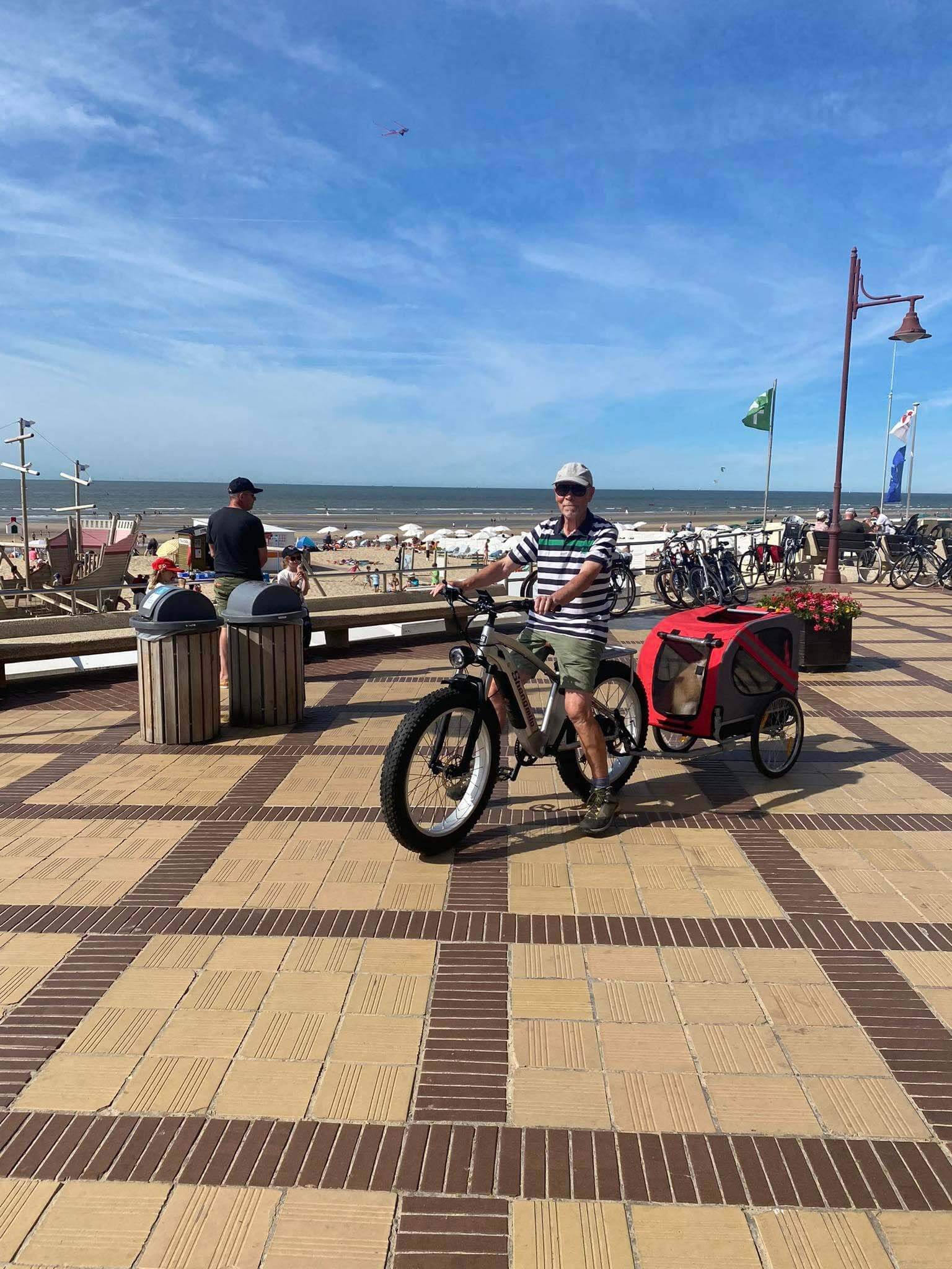 An old man goes to the beach on an electric bicycle