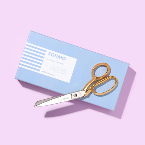 A pair of sewing scissors in a blue gift box