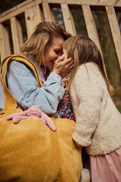 mom with daughter and yellow corduroy bag by bettys home