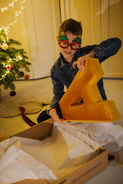 teenager opening christmas box by bettys home with letter pillow inside